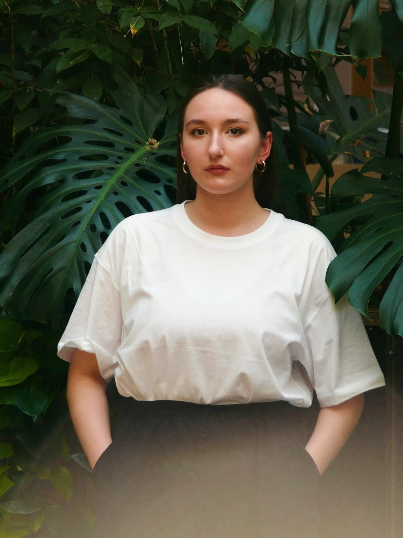 Zosia Paszkiet portrait among monstera leaves