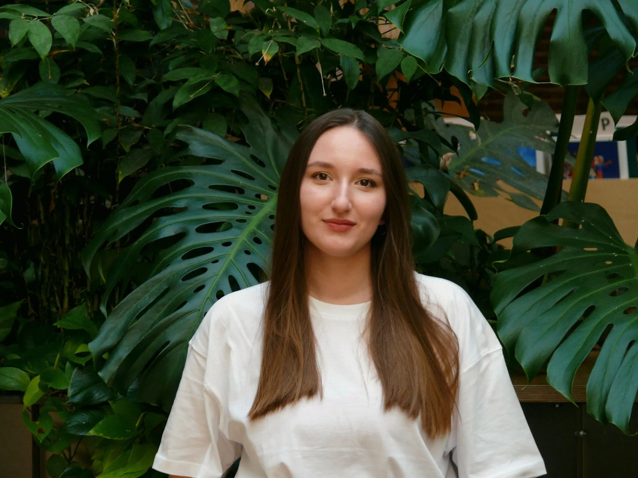 Zosia Paszkiet portrait among monstera leaves